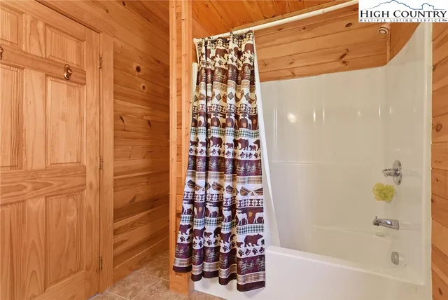 a bathroom with a bathtub and shower