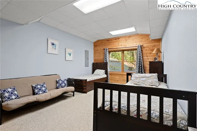 a bedroom with furniture and large windows