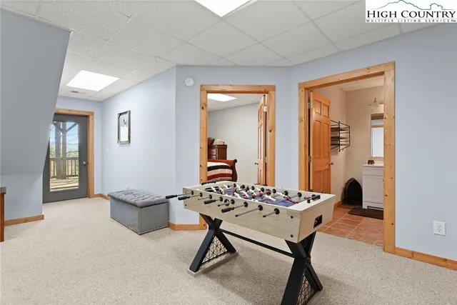 a view of a livingroom with furniture and mirror