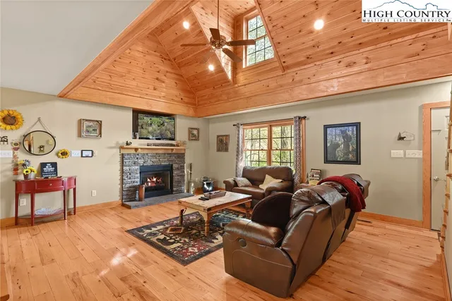 a living room with furniture a fireplace and a table