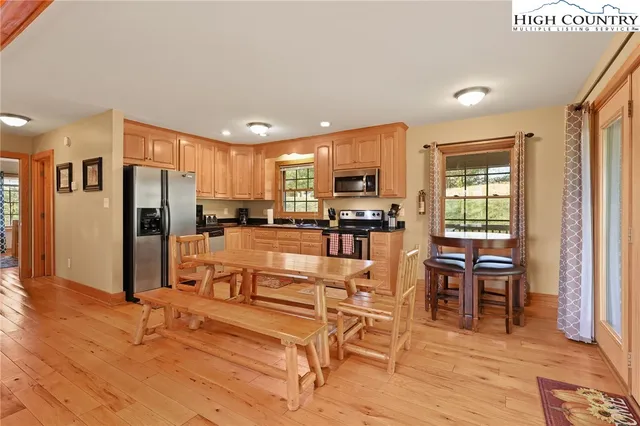 a kitchen with stainless steel appliances kitchen island granite countertop a refrigerator and cabinets