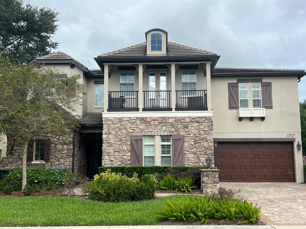 a front view of a house with a garden