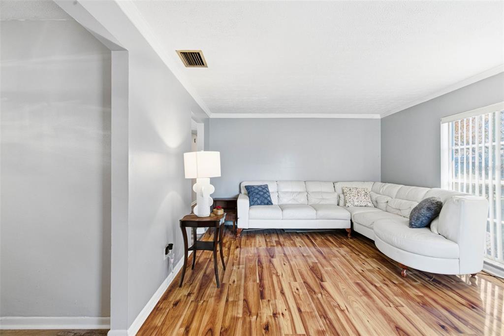 4120 East Temple Heights Road Tampa, FL 33617 - Photo 4 of 55 a living room with furniture and a wooden floor