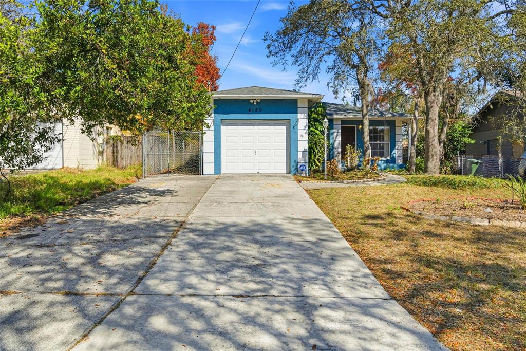 4120 East Temple Heights Road Tampa, FL 33617 - Photo 7 of 55 a front view of a house with a yard and trees