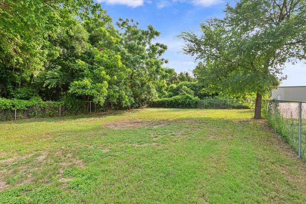 3109 North 20th Street Waco, TX 76708 - Photo 23 of 24 Expansive green lawn surrounded by mature trees