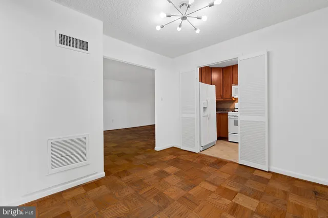 a kitchen with granite countertop wood cabinets stainless steel appliances and a sink