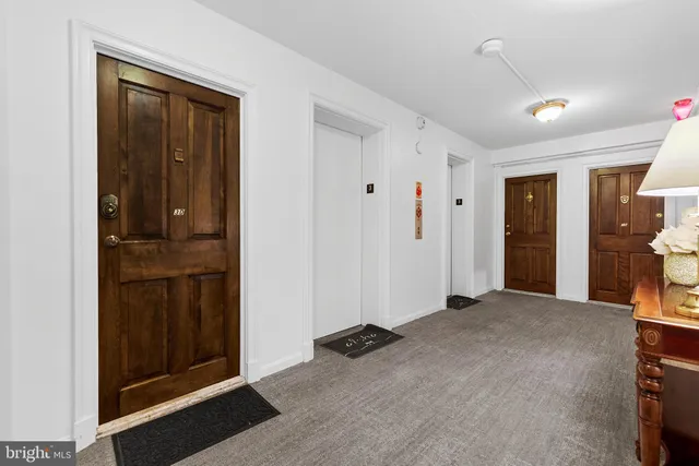 a bedroom with furniture and large windows