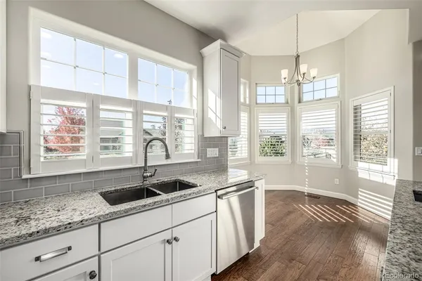 a kitchen with sink and large window