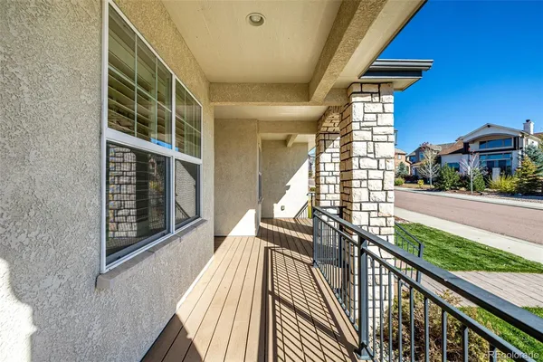 a view of balcony with wooden floor and fence