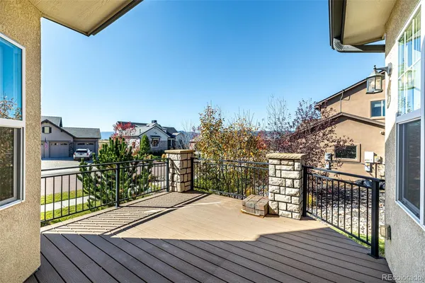 a view of a balcony with wooden floor and fence