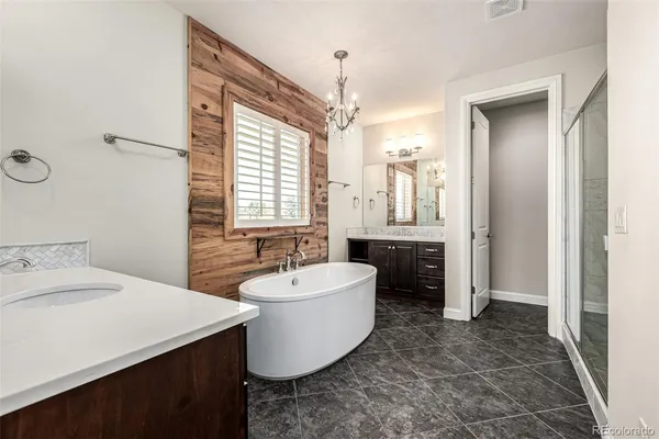 a spacious bathroom with a bathtub sink and mirror