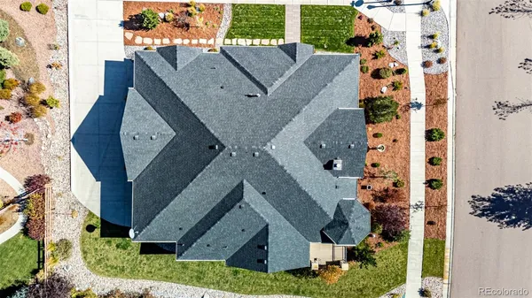 an aerial view of a house with a yard