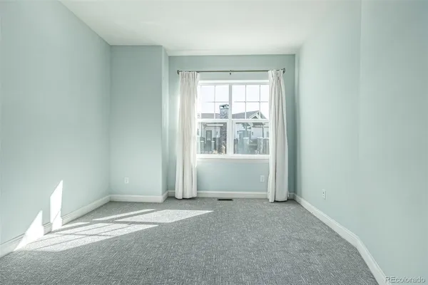 an empty room with closet and a hallway