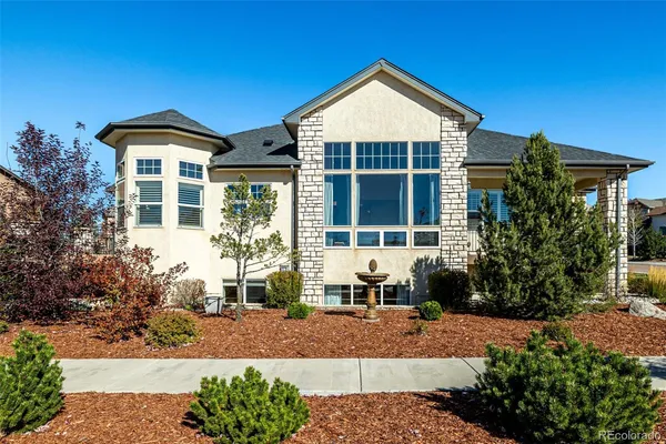 a front view of a house with a yard and outdoor seating