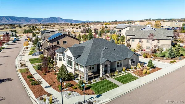 an aerial view of multiple houses with a yard