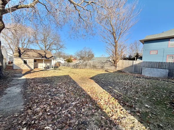 a view of yard covered with snow in front of house