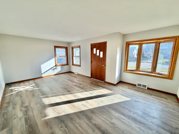 a view of a room with wooden floor and window