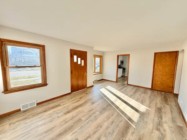 a view of a room with wooden floor and closet
