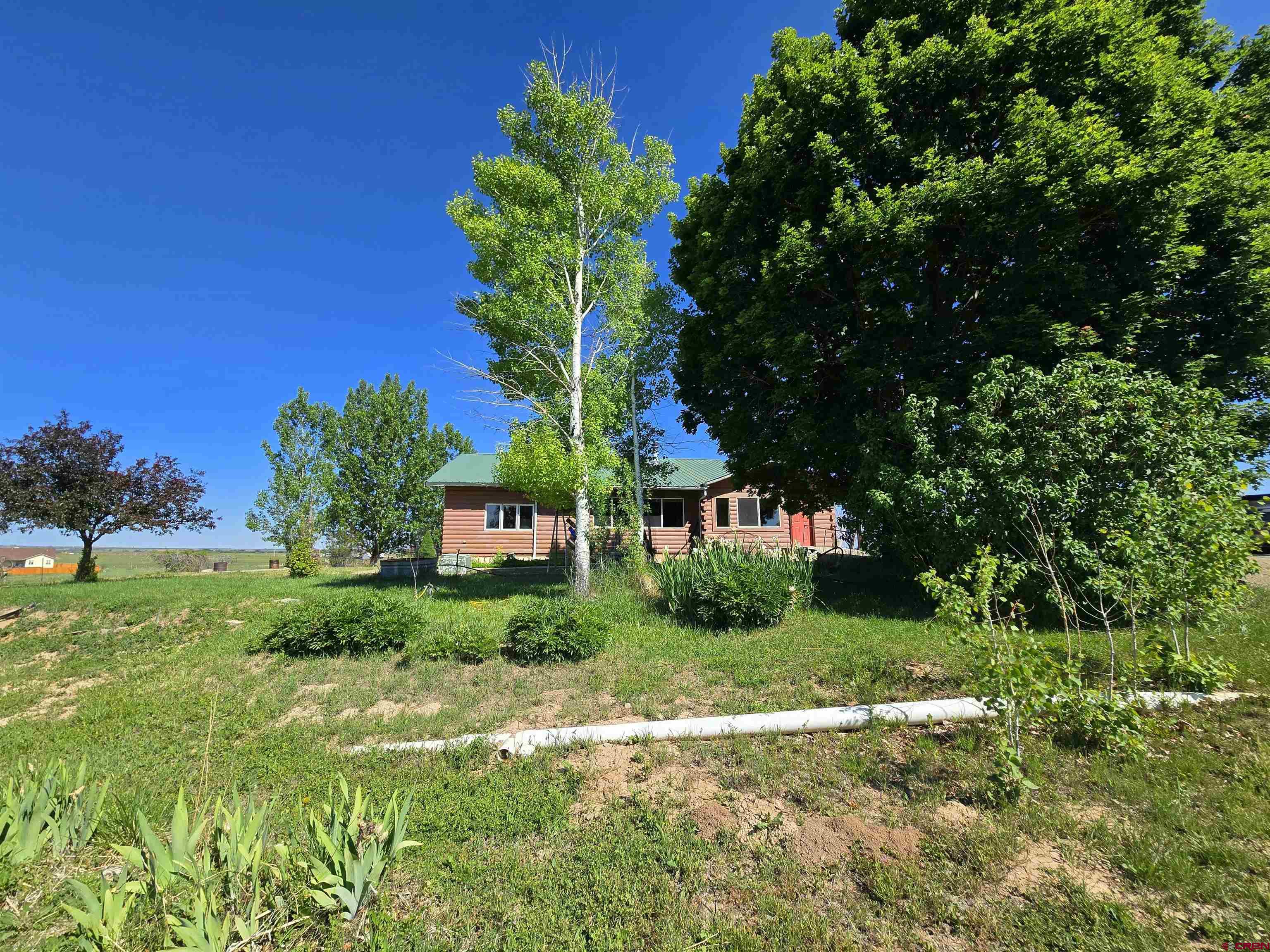 23435 County Rd M Cortez, CO 81321 - Photo 24 of 27 a front view of a house with garden