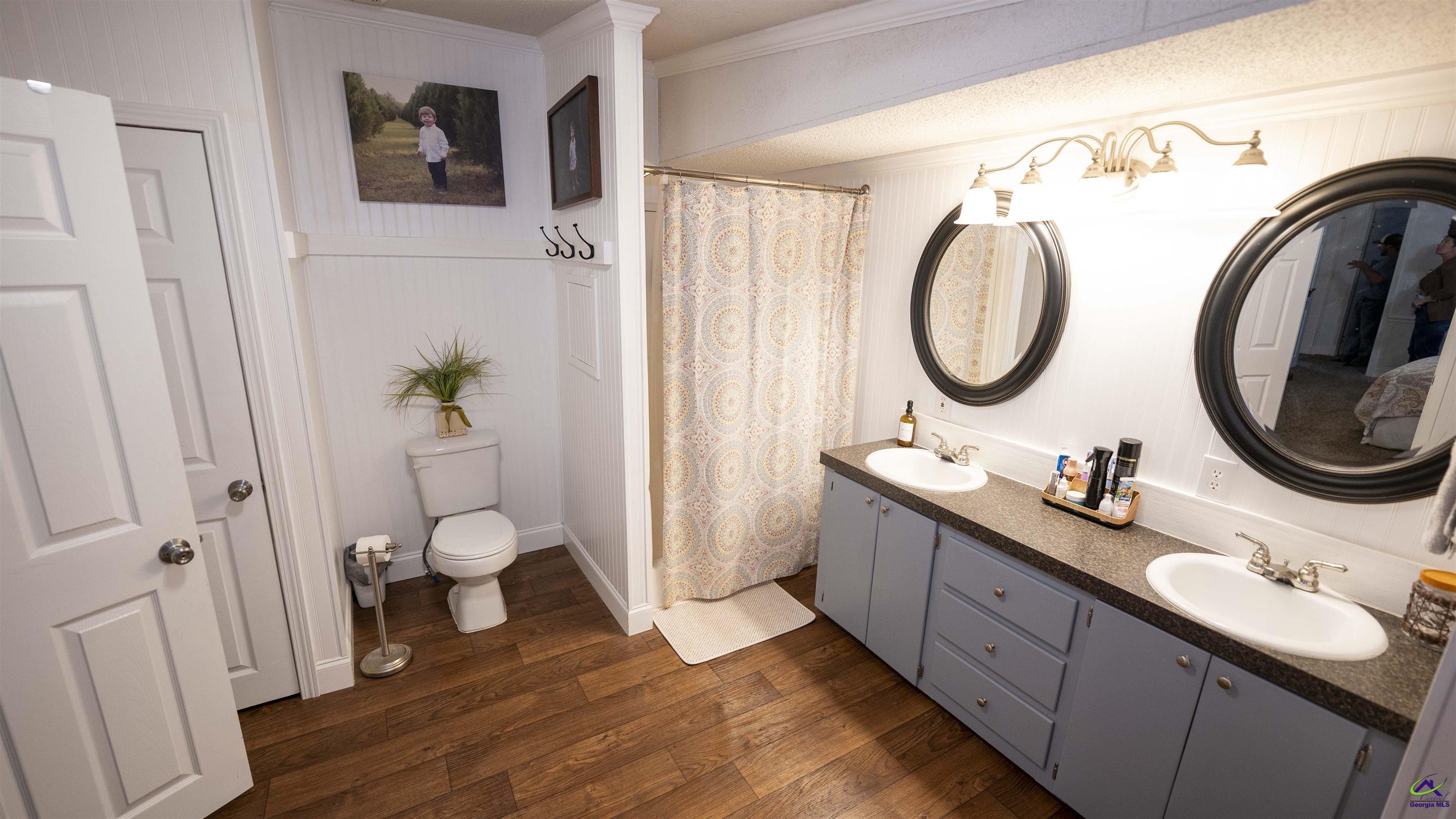 500 Old Milledgeville Road Cochran, GA 31014 - Photo 39 of 48 a bathroom with a granite countertop sink and a mirror