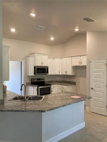 a view of a kitchen with a sink and a window