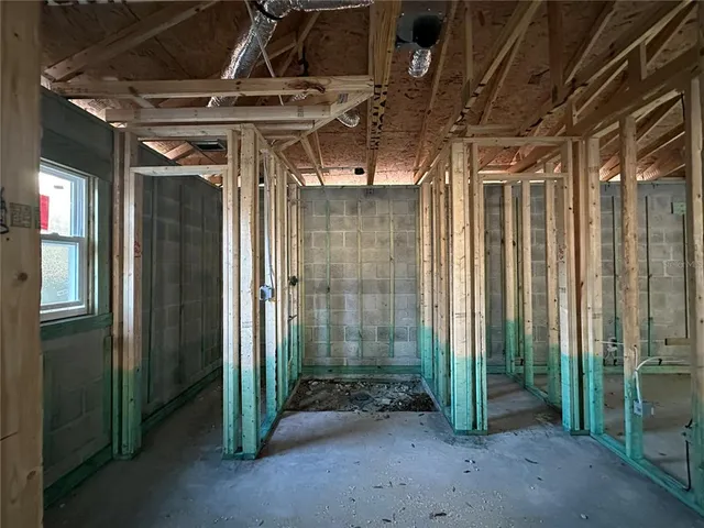 a view of an empty room with large windows