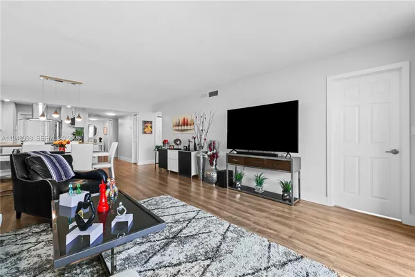 a living room with lots of furniture and wooden floor