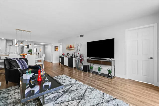 a living room with lots of furniture and wooden floor