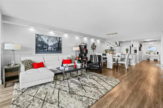 a living room with lots of furniture and a wooden floor