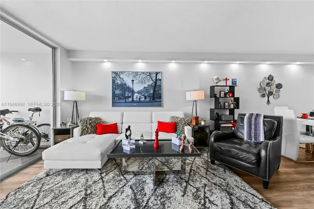 a view of a kitchen with stainless steel appliances granite countertop a stove a sink a refrigerator and a wooden floor