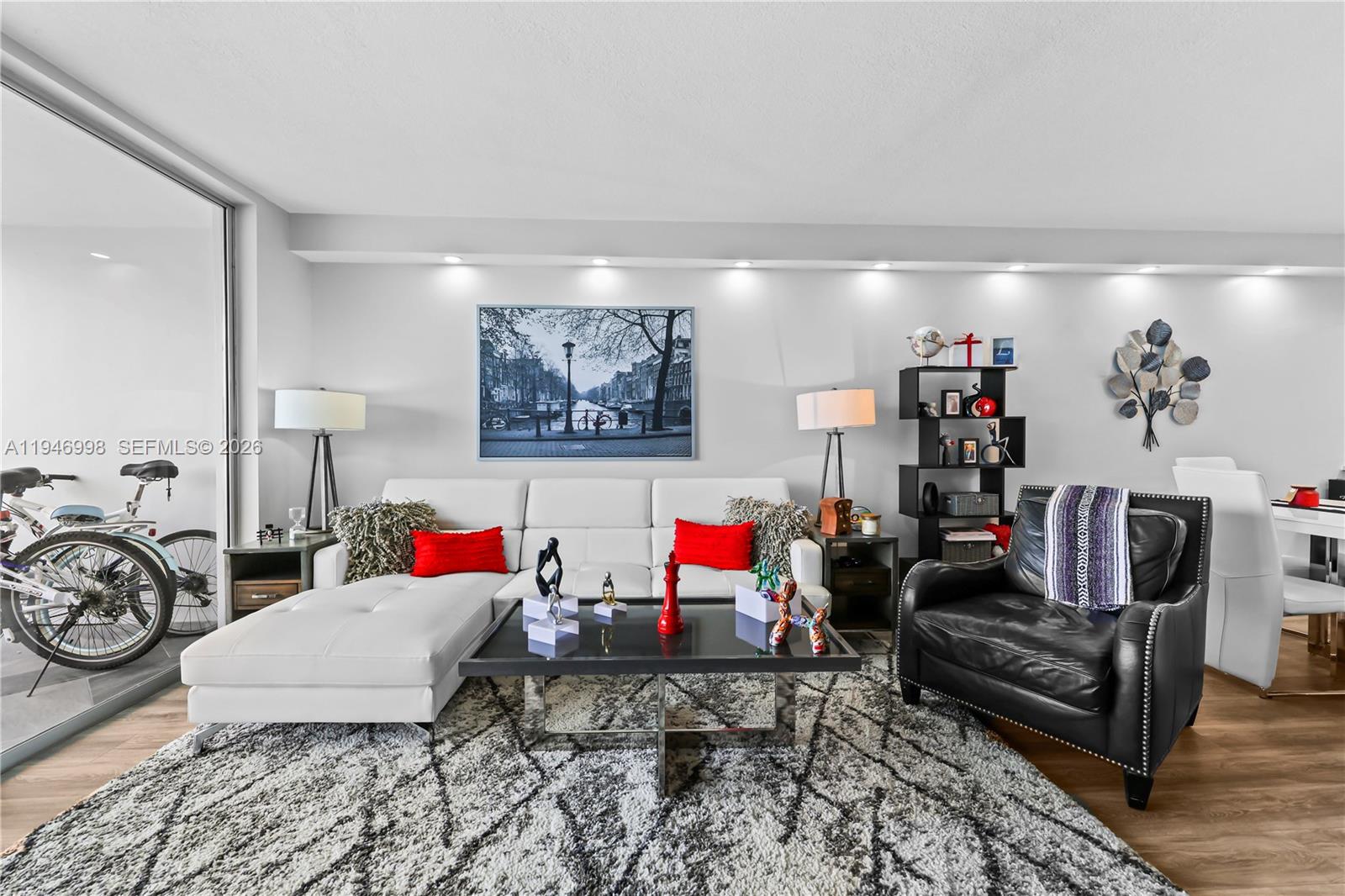 2661 South Course Drive, Unit 510 Pompano Beach, FL 33069 - Photo 16 of 49 a living room with lots of furniture and a wooden floor