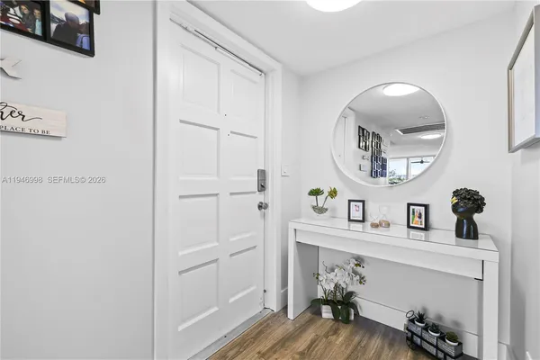 a view of a hallway with wooden floor
