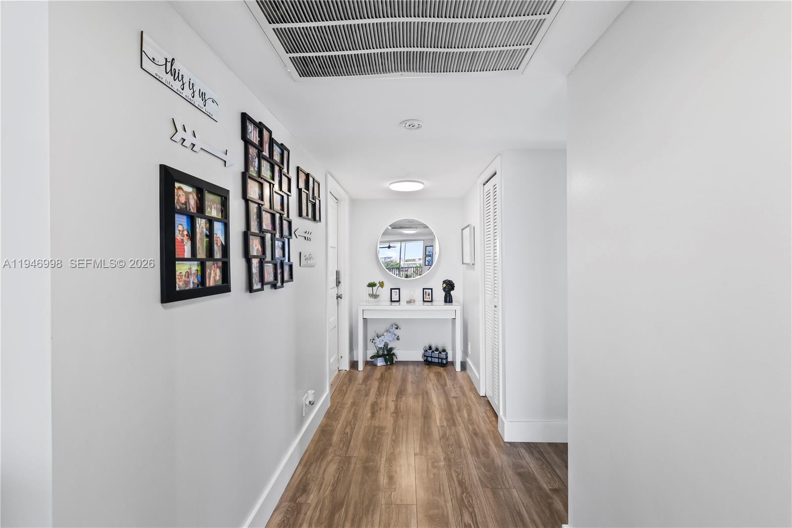 2661 South Course Drive, Unit 510 Pompano Beach, FL 33069 - Photo 19 of 49 a view of a hallway with wooden floor
