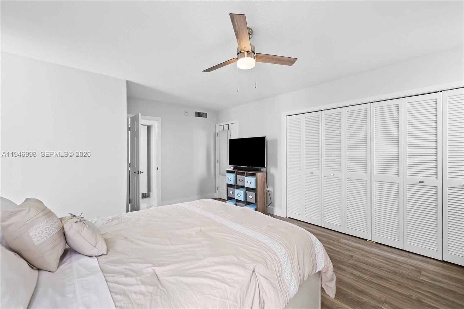 2661 South Course Drive, Unit 510 Pompano Beach, FL 33069 - Photo 21 of 49 a bedroom with a bed and a flat screen tv