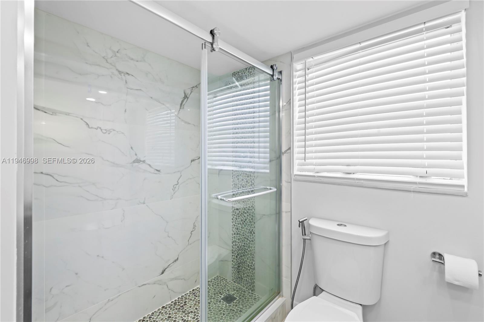 2661 South Course Drive, Unit 510 Pompano Beach, FL 33069 - Photo 23 of 49 a bathroom with a toilet and a shower