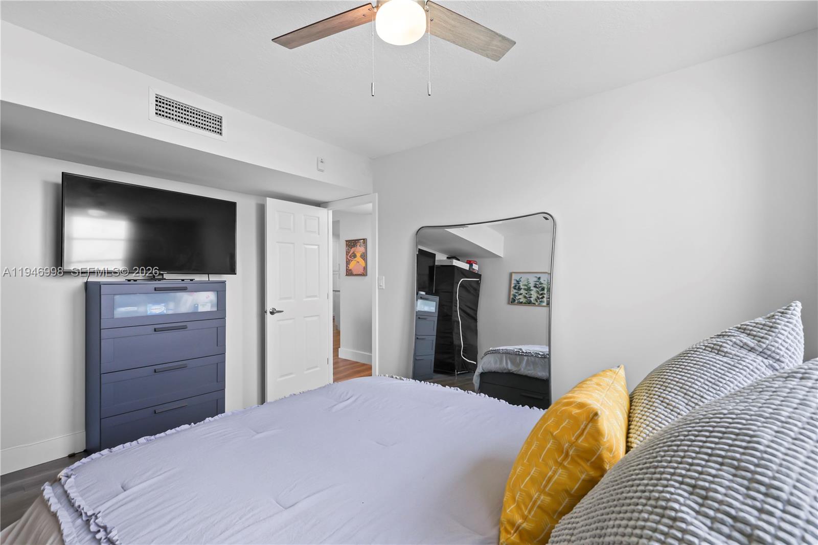 2661 South Course Drive, Unit 510 Pompano Beach, FL 33069 - Photo 25 of 49 a bedroom with a bed and a flat screen tv