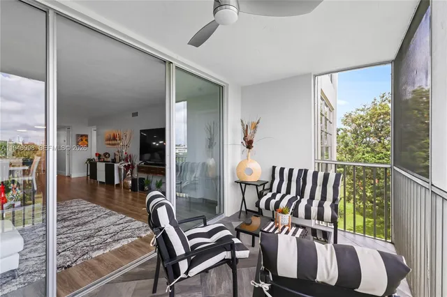 a view of a livingroom with furniture and floor to ceiling window