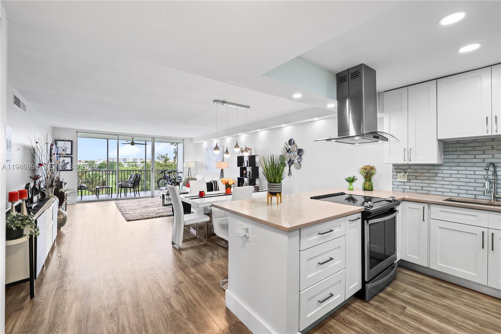 2661 South Course Drive, Unit 510 Pompano Beach, FL 33069 - Photo 3 of 49 a kitchen with a sink stove and wooden cabinets