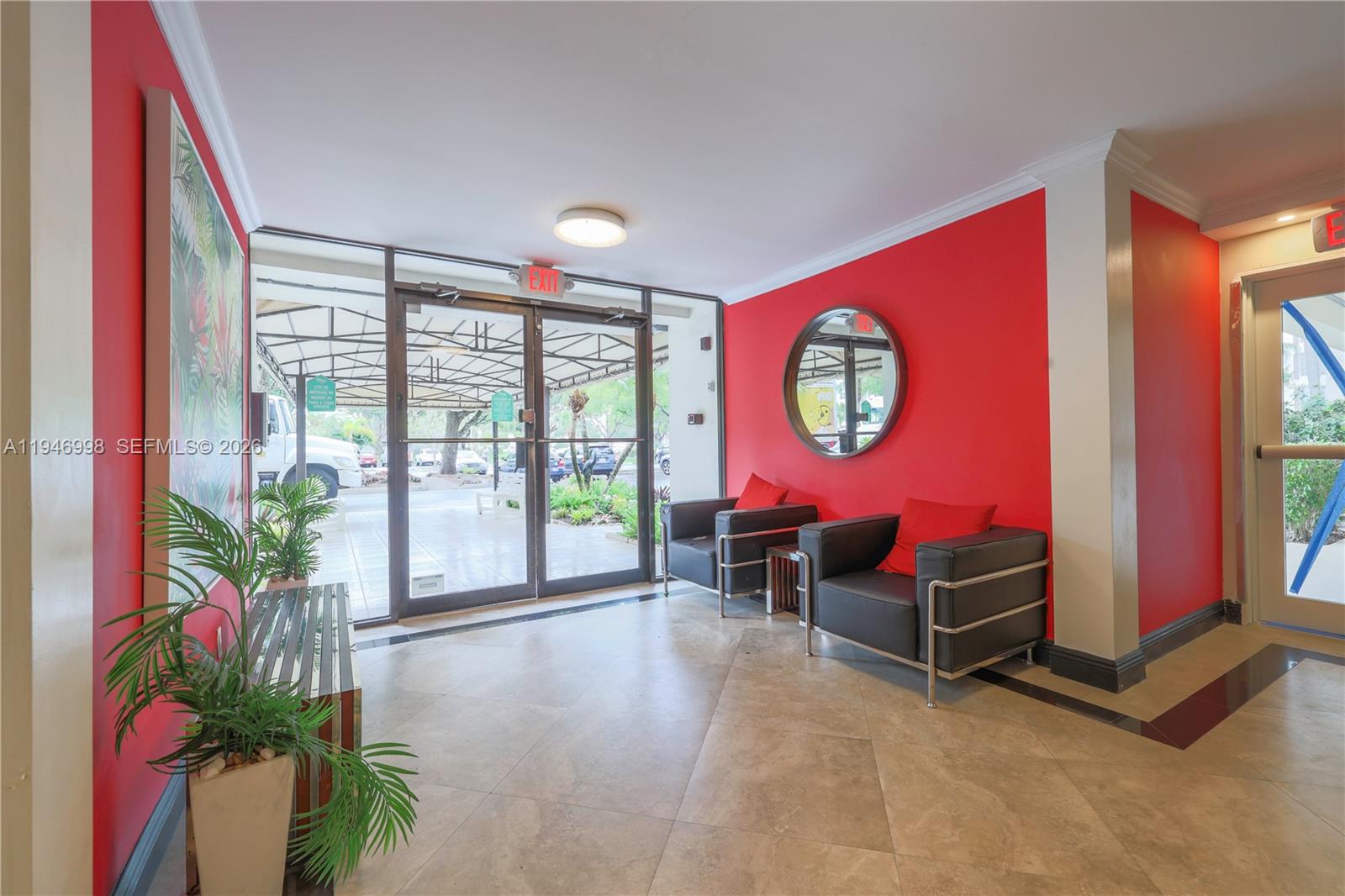 2661 South Course Drive, Unit 510 Pompano Beach, FL 33069 - Photo 39 of 49 a view of a livingroom with furniture and a potted plant