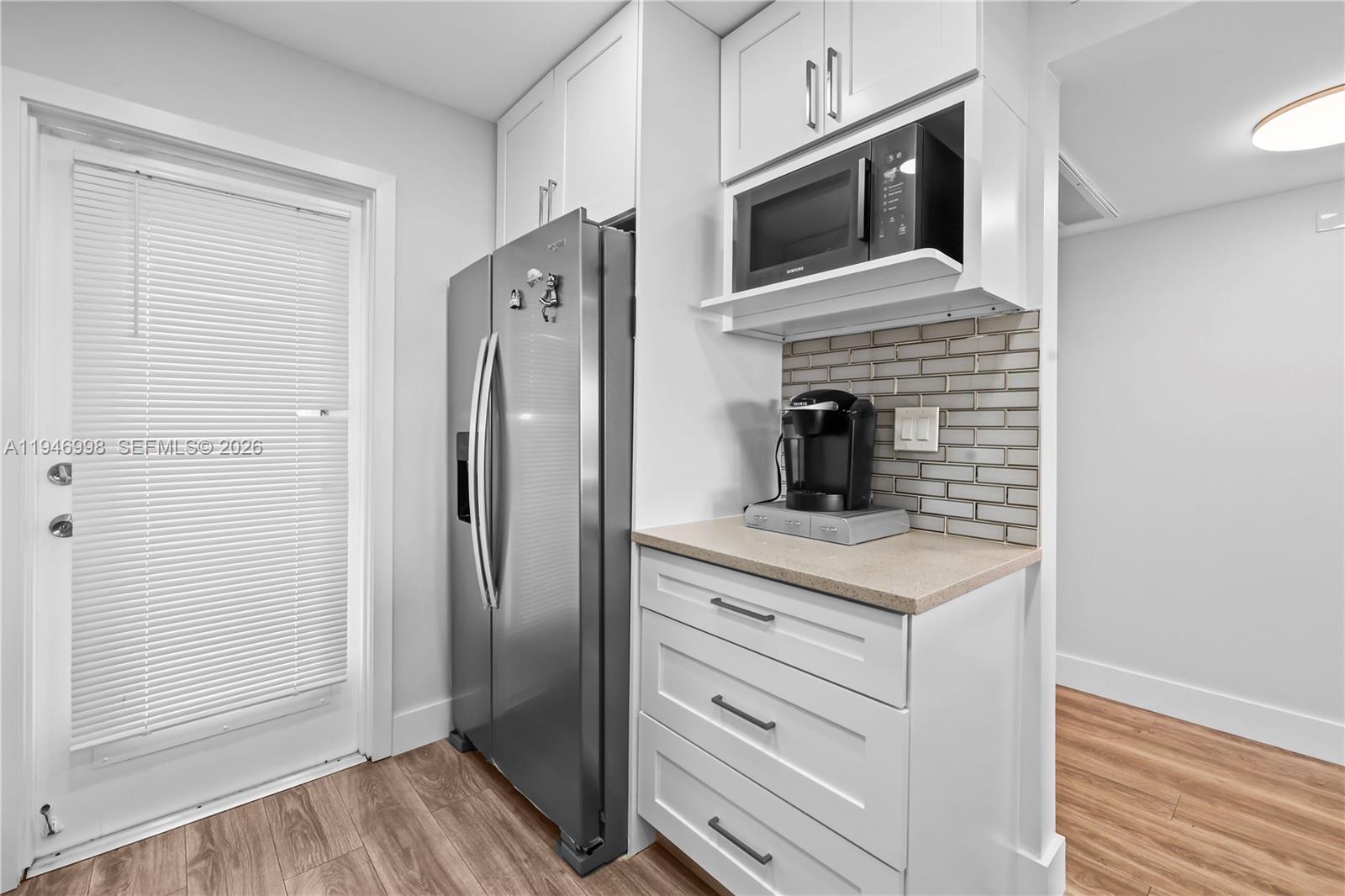 2661 South Course Drive, Unit 510 Pompano Beach, FL 33069 - Photo 4 of 49 a kitchen with granite countertop cabinets stainless steel appliances and wooden floor