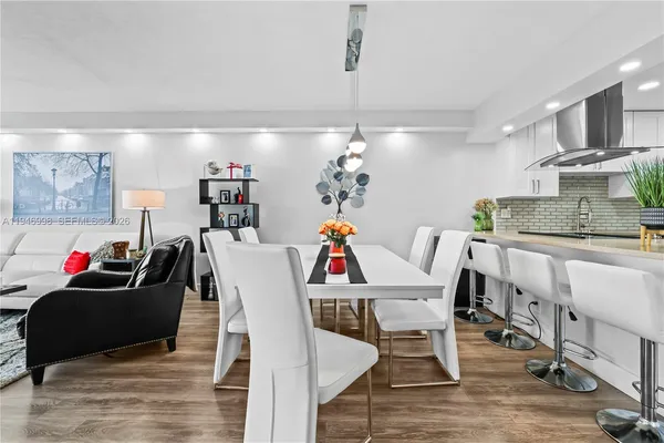 a view of a dining room with furniture and wooden floor