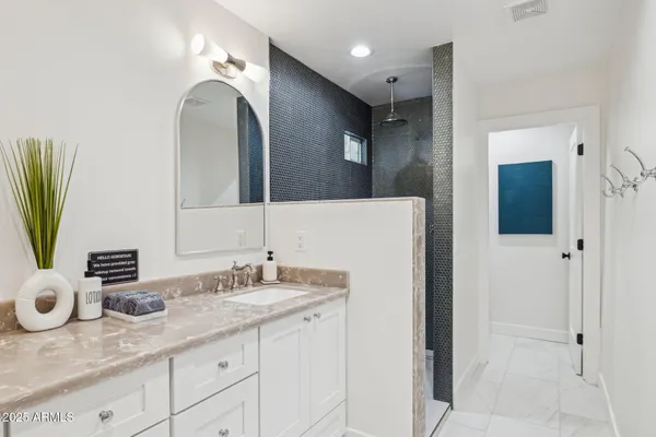 a bedroom with a large bed and a potted plant