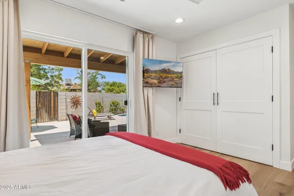 a bed sitting in a bedroom next to a window