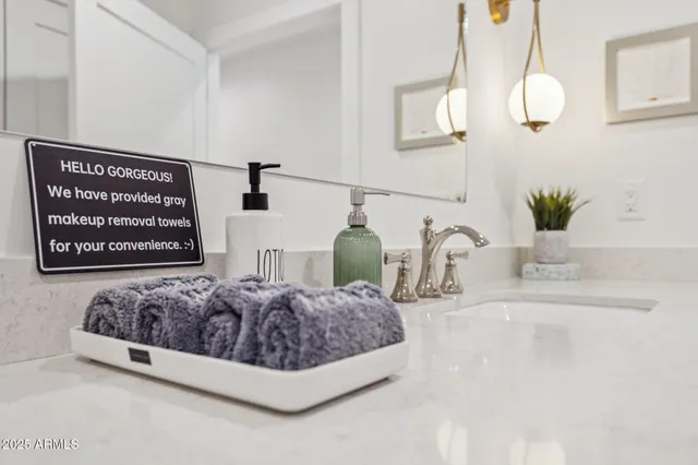 a bathroom with a granite countertop sink mirror and toilet
