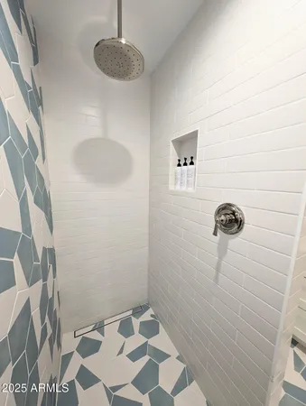 a living room with furniture and a mirror