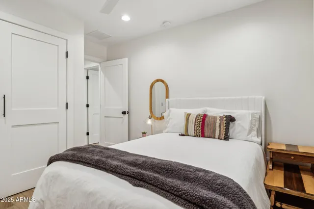 a bedroom with a bed and a painting on the wall