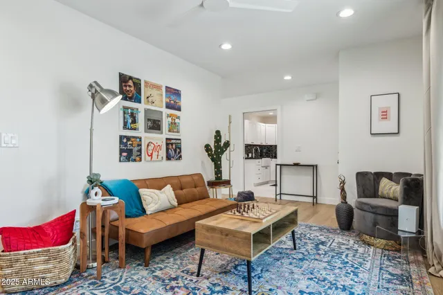 a living room with furniture and painting on the wall