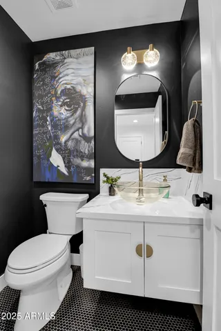 a bathroom with a toilet a sink and mirror