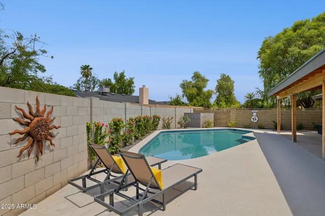 a view of a backyard with plants and a patio