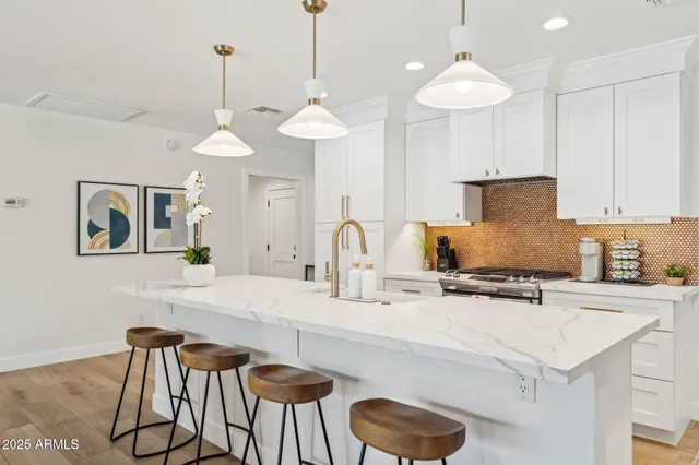 a stove top oven sitting inside of a kitchen
